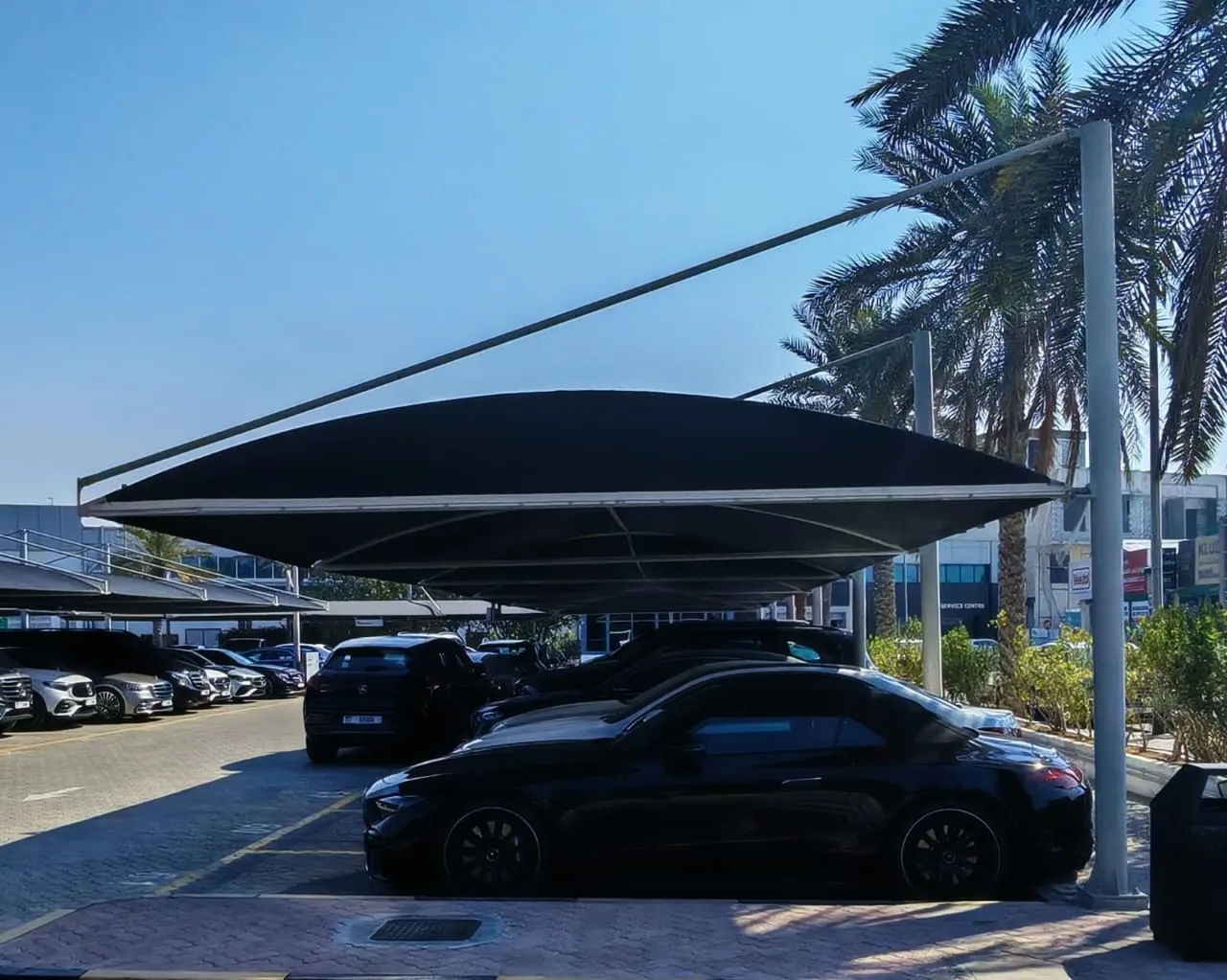 Black cantilever car parking shade at a car dealership in Dubai