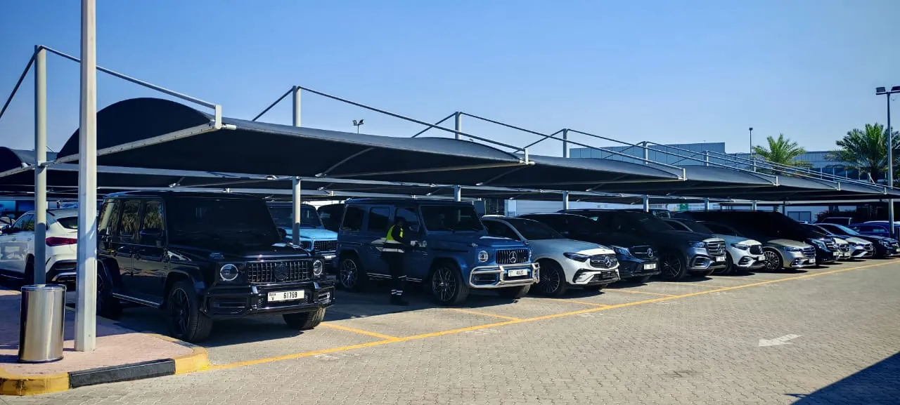 Row of black car parking shades at a car showroom in Dubai