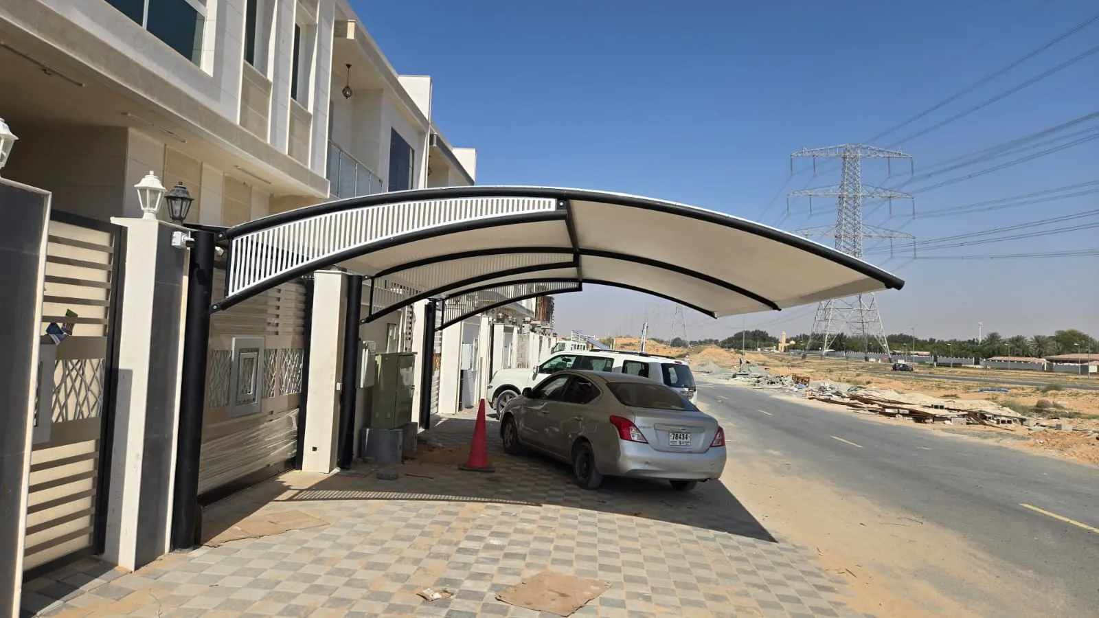 Arch design car parking shade outside a villa in the UAE